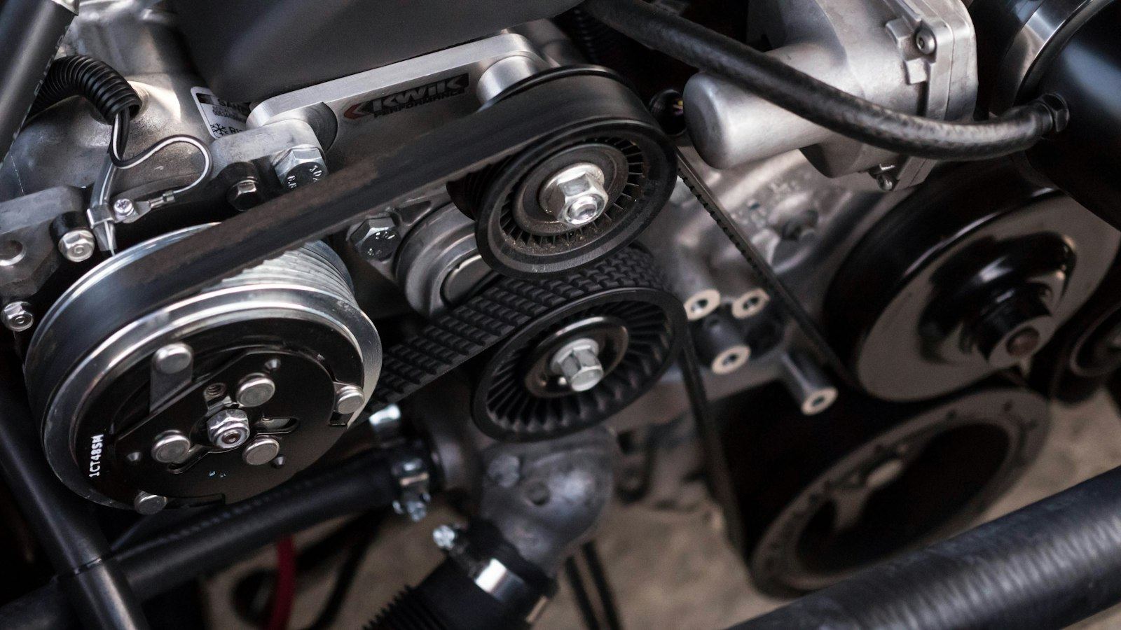 Close-up of an engine bay with belts and pulleys